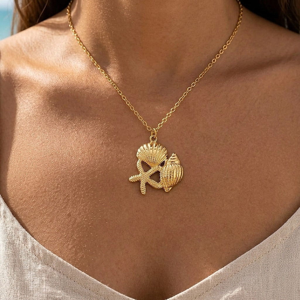 Starfish, seashell and clam pendant necklace worn at the neckline
