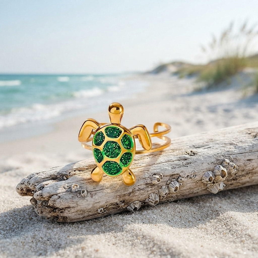 Gold turtle ring with green zirconia shell on driftwood