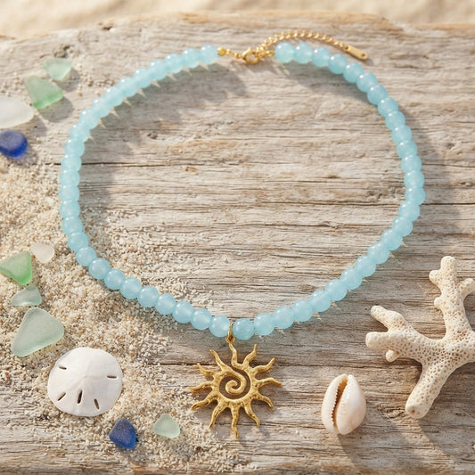 Light blue beaded necklace with a gold sun charm