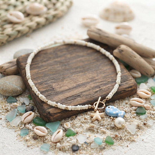 White and gold ceramic fish and pearl necklace
