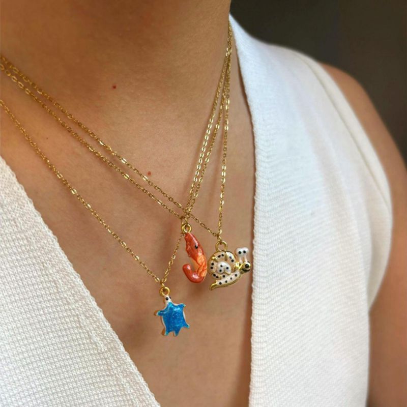 Turtle, lobster and snail necklaces layered together
