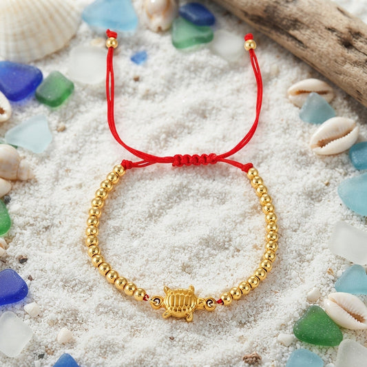 Red and gold turtle bead braided bracelet