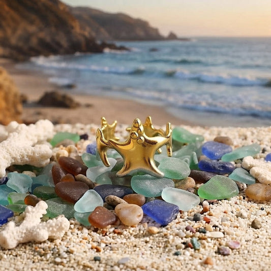 Gold multiple starfish ring on sea glass and sand