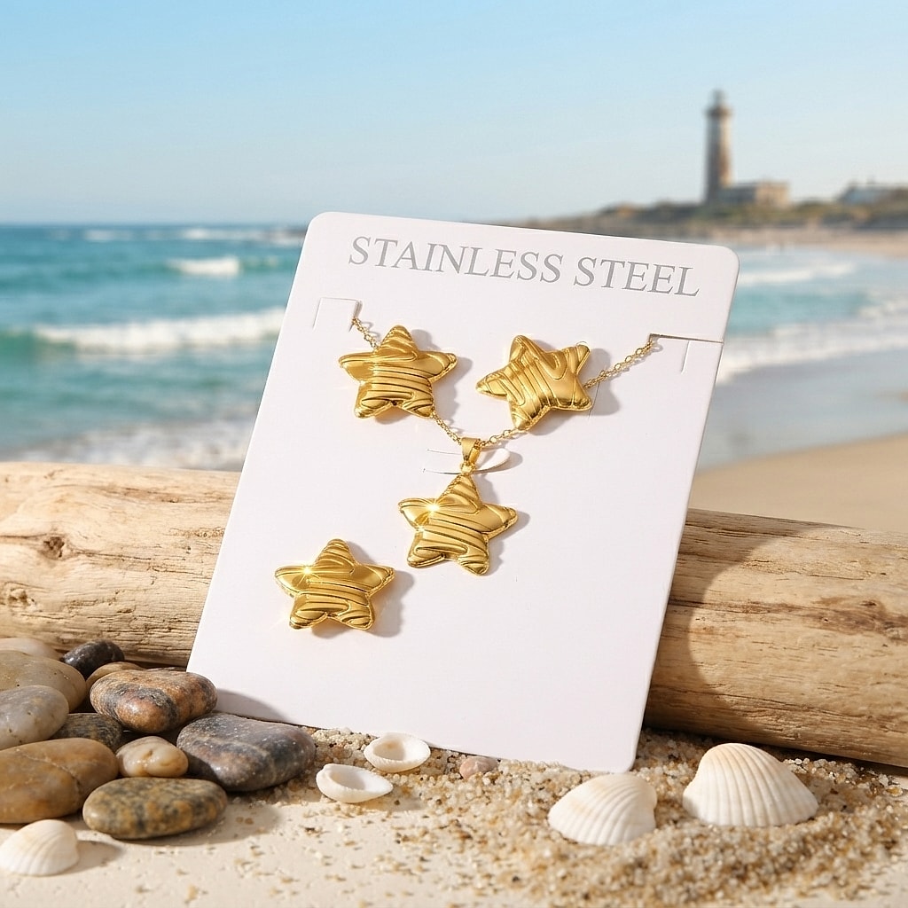 Striped gold star earrings, necklace and ring set on a card by the sea